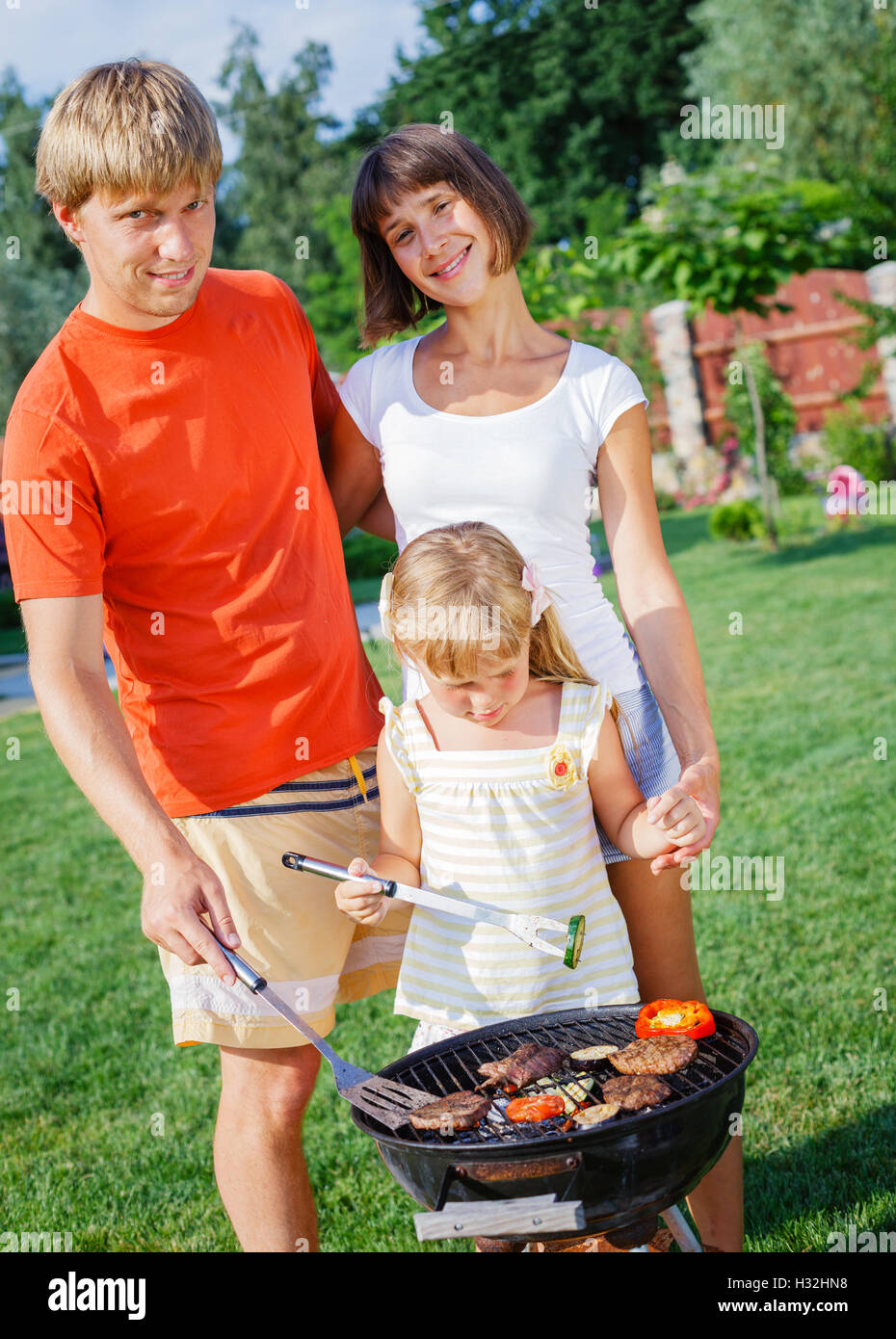 Happy family with barbecue Stock Photo