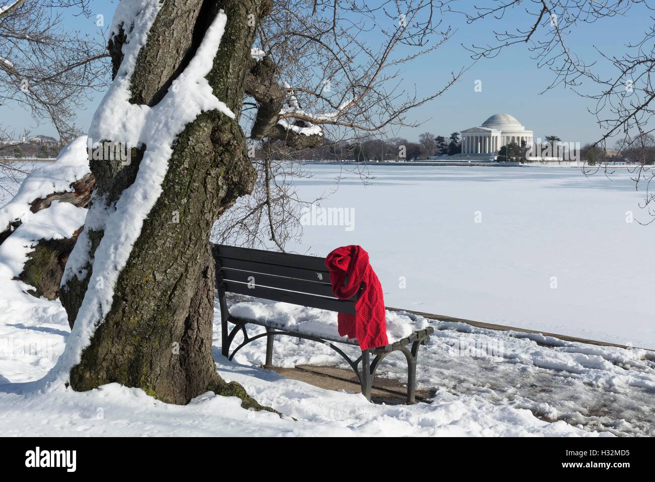A red scarf hangs on an empty bench along the Tidal Basin in Washington, DC. Stock Photo