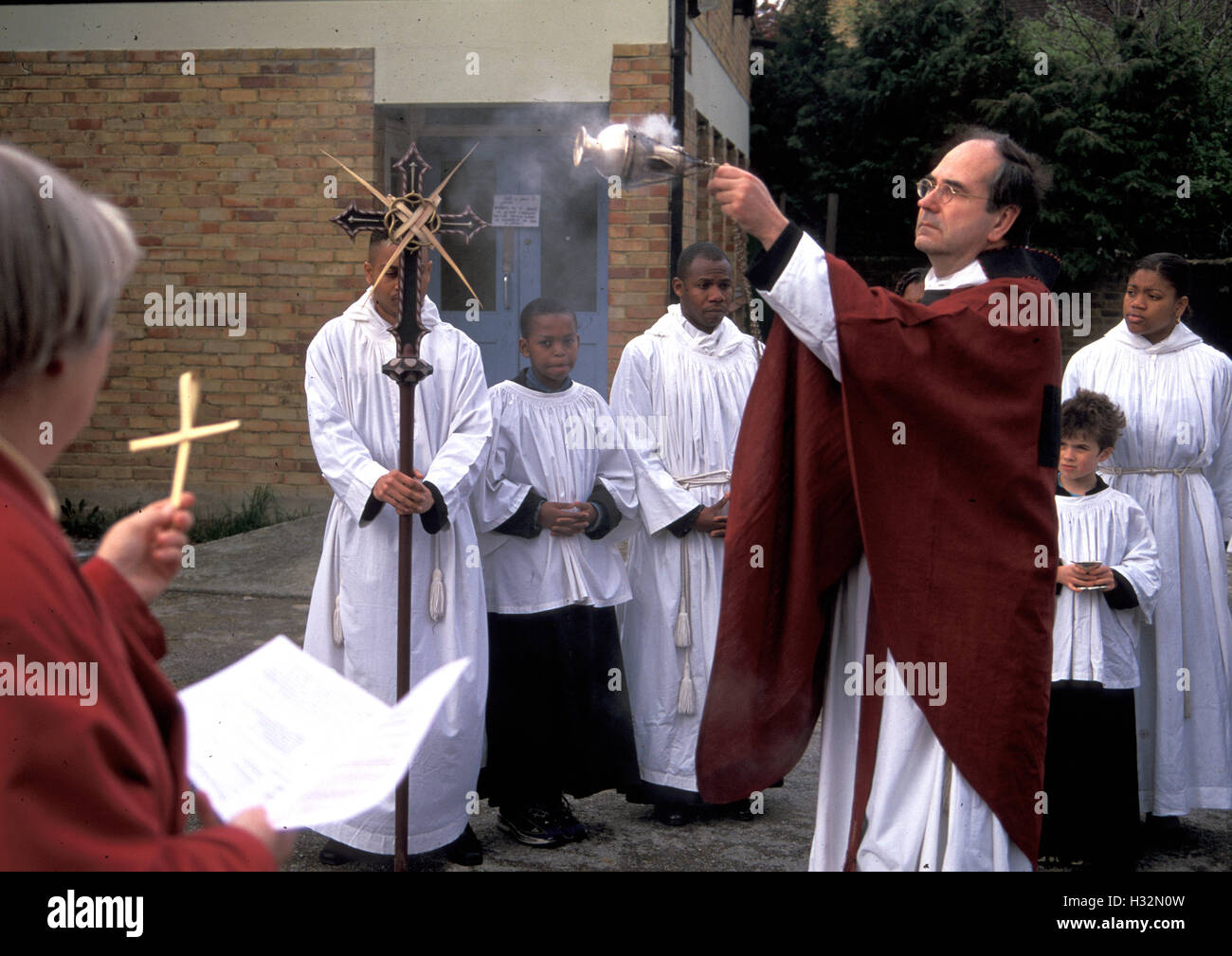 Priest swinging censer, Palm Sunday service, London Stock Photo