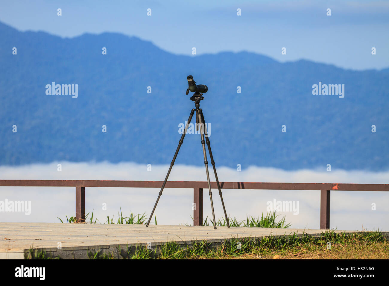 Birdwatching monocular or spotting scope on a tripod in forest Stock Photo