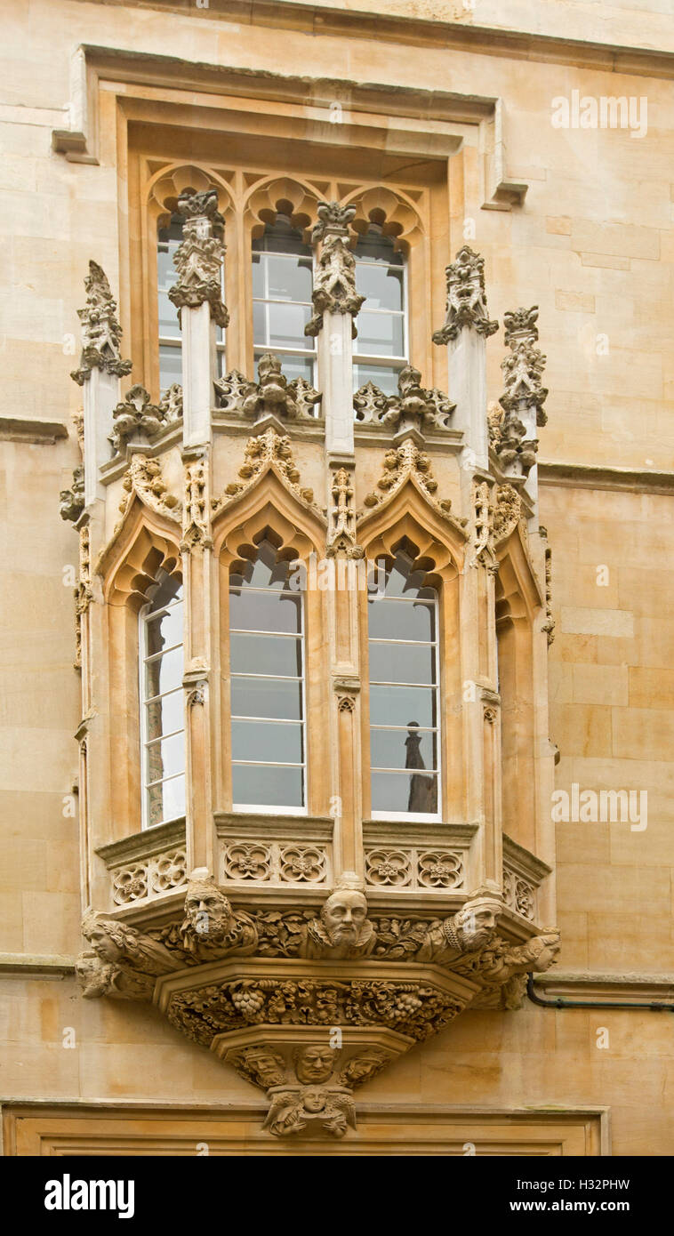 Bay window surrounded by highly decorative gothic style stone carving at entrance to historic Pembroke college in Oxford England Stock Photo