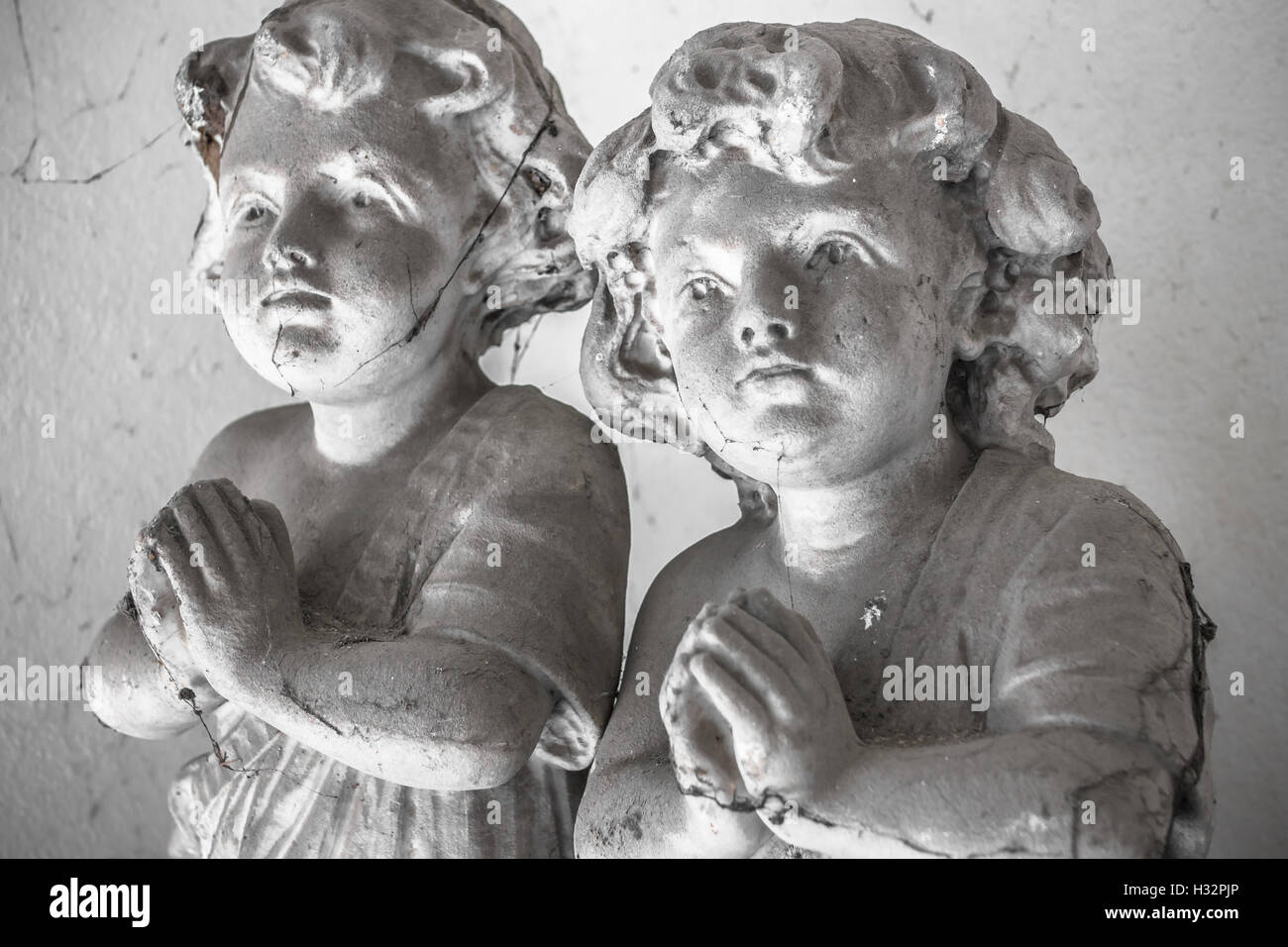 Statues of children in prayer covered with cobwebs Stock Photo Alamy