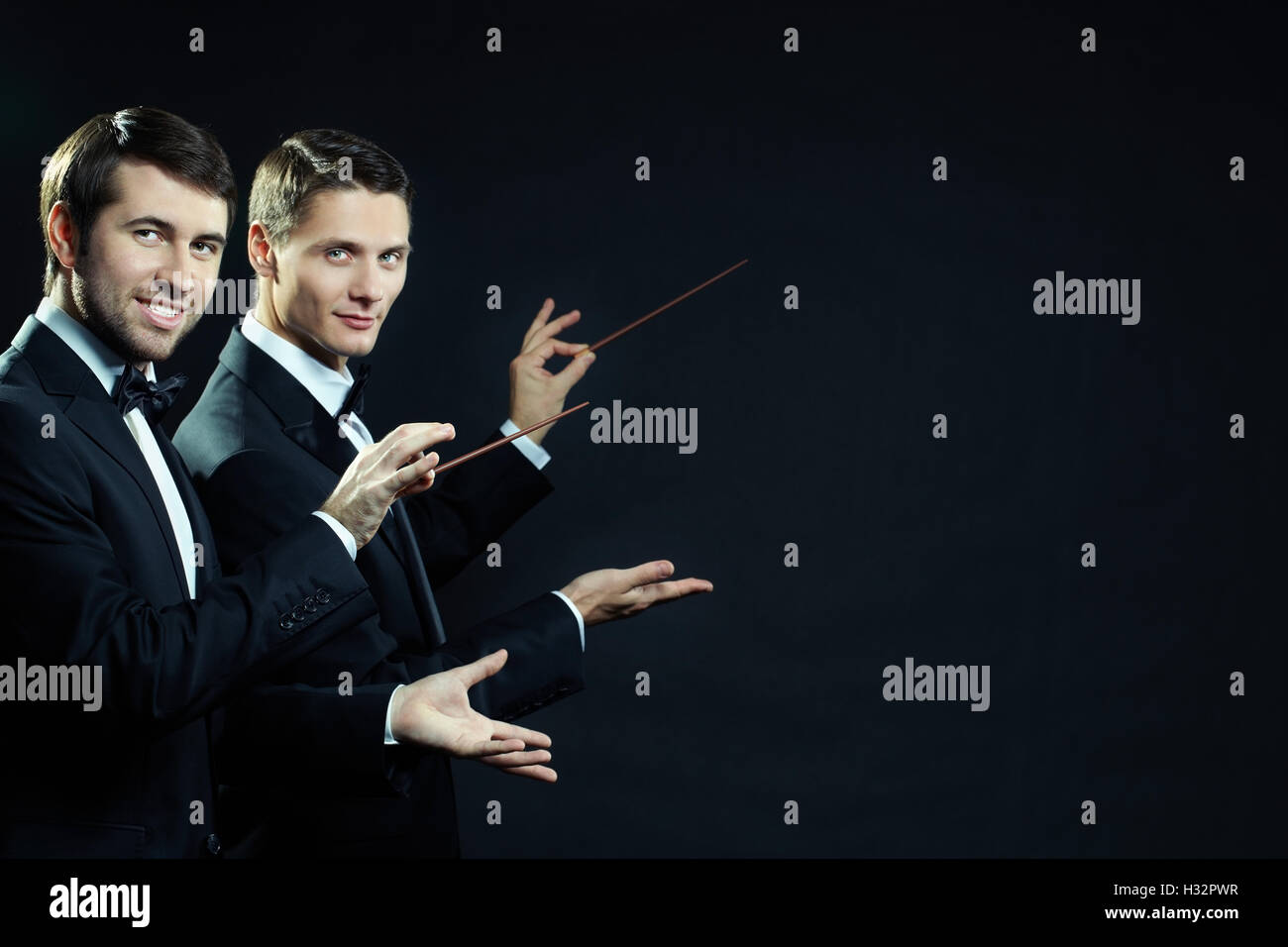 Men with wands Stock Photo