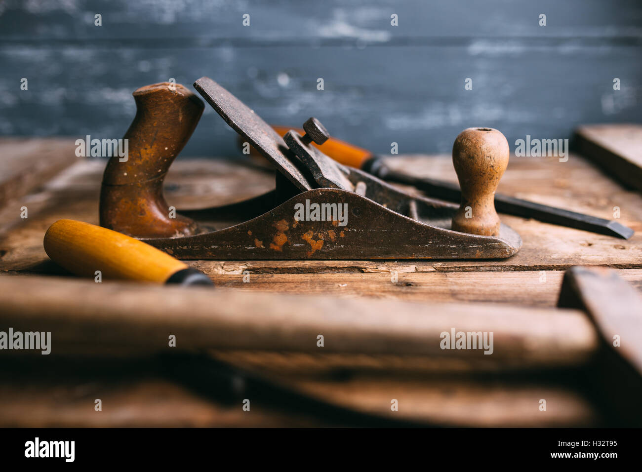 Old vintage hand tools on wooden background. Carpenter workplace Stock
