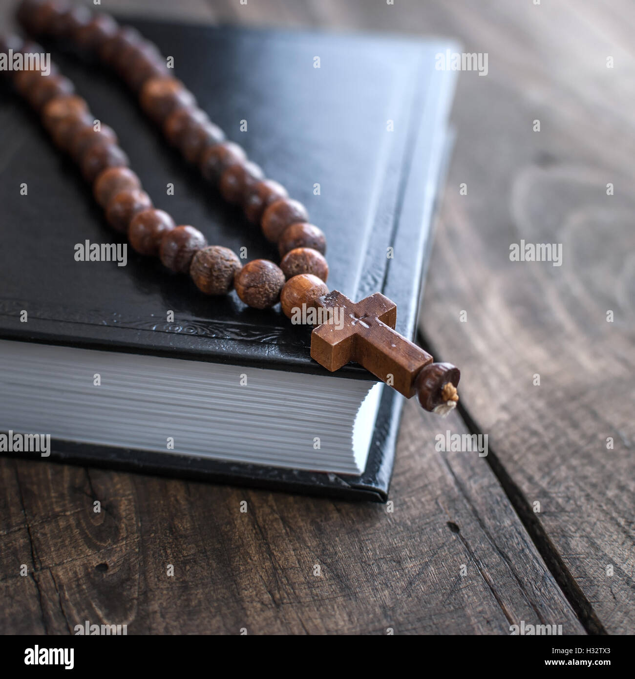 Close up photo of Wooden rosary beads and holy bible Stock Photo