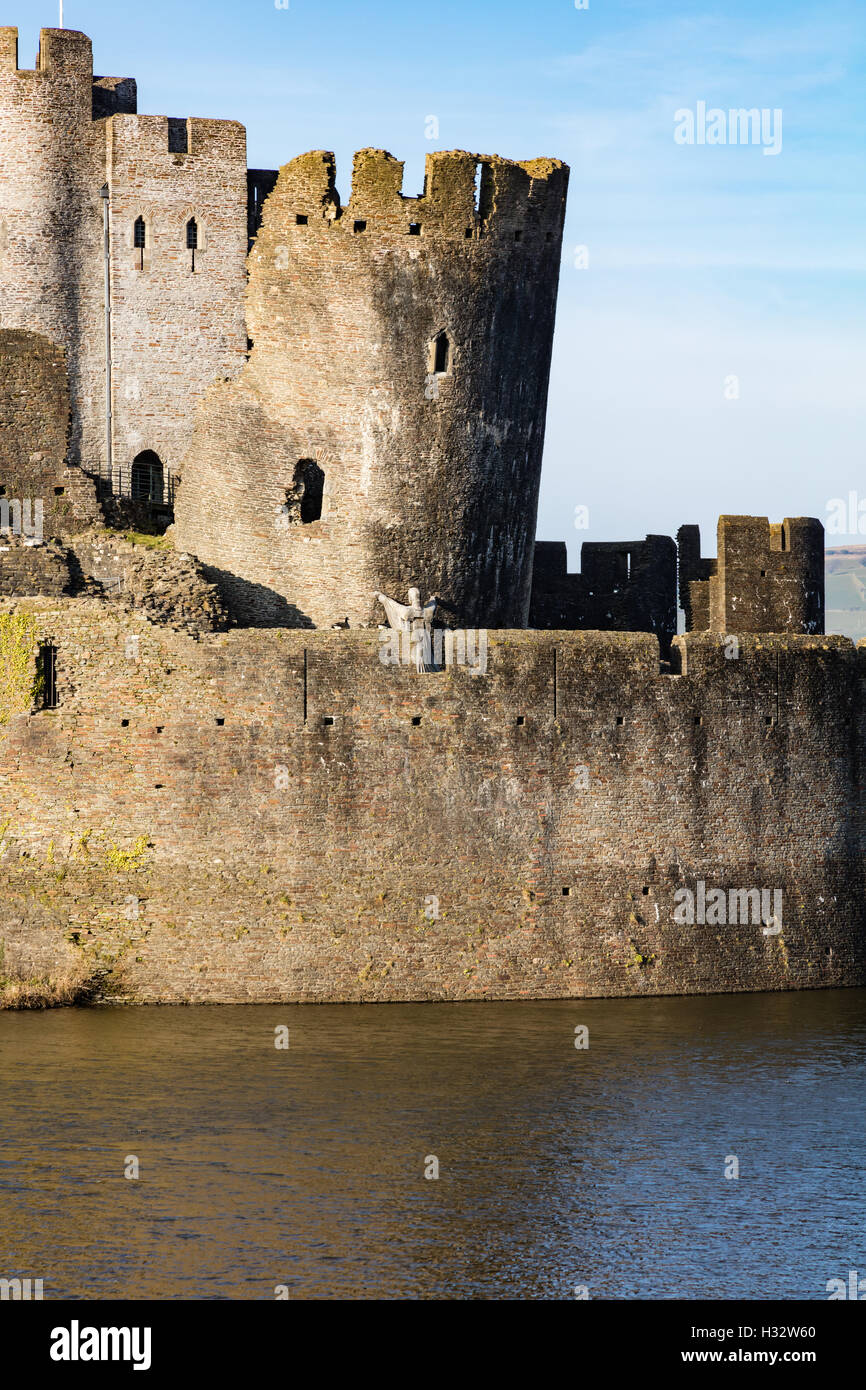 The moat and walls and leaning tower of Caerphilly Castle in the low evening light, Caerphilly, Wales, UK Stock Photo