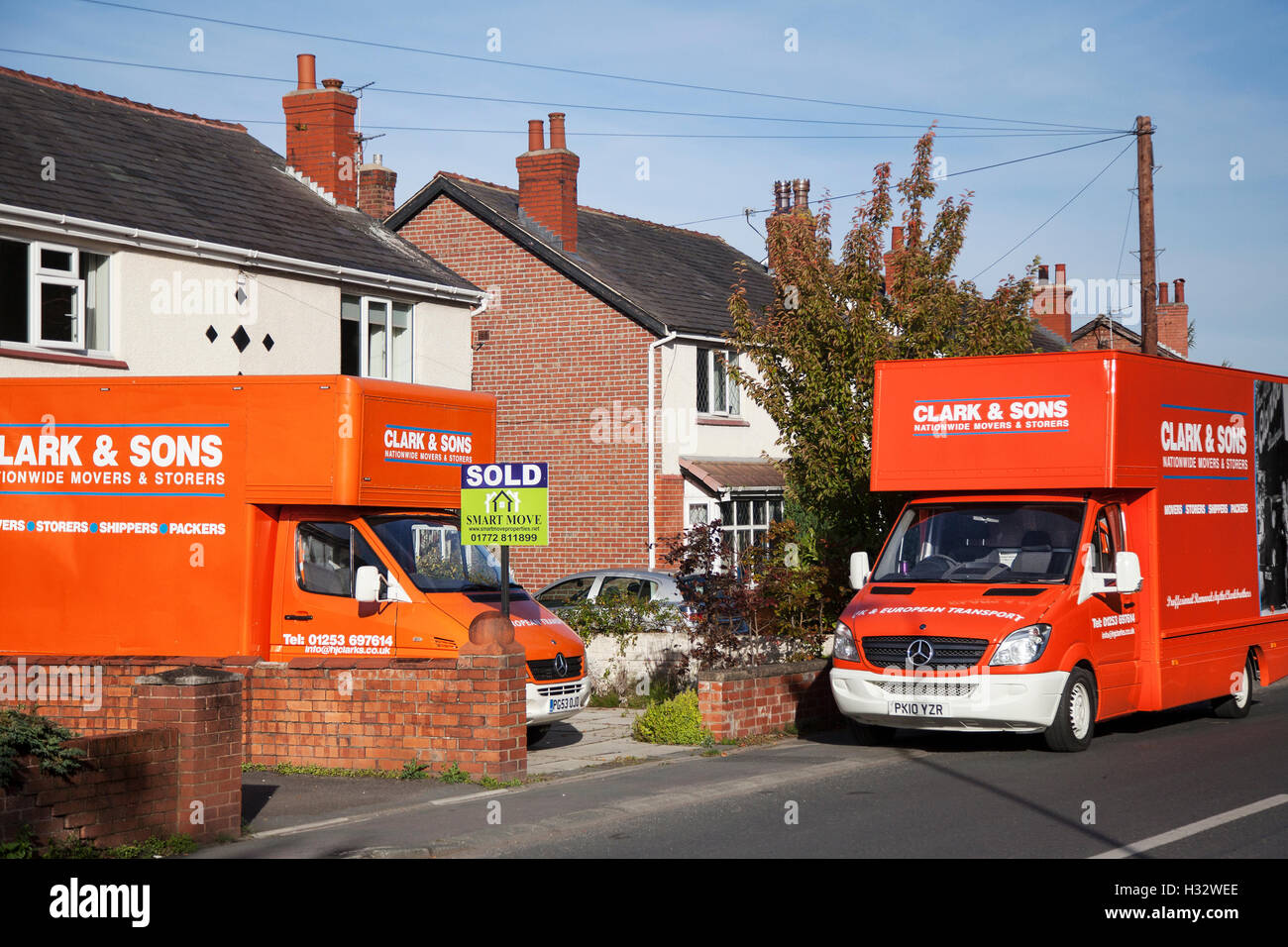 Clark & Sons Removal van: House sold sign by Smart Move and removal vans in  Hesketh Bank, Lancashire, UK Stock Photo - Alamy