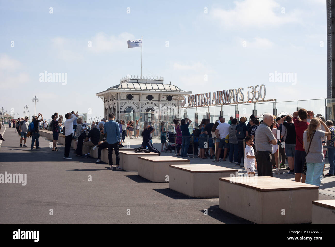 Tourists queuing to go on the i360, Brighton, Sussex, UK Stock Photo