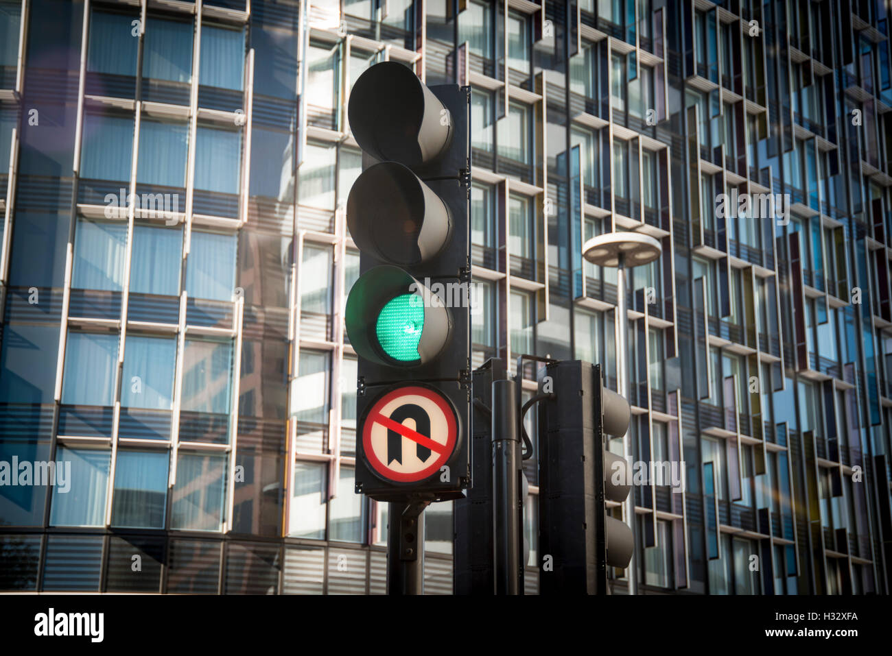 green traffic light with no u turn sign. Stock Photo