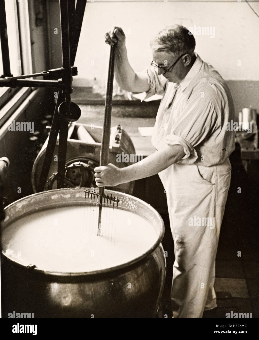 Portrait of cheese maker carrying hard cheeses - Stock Image - F023/1666 -  Science Photo Library