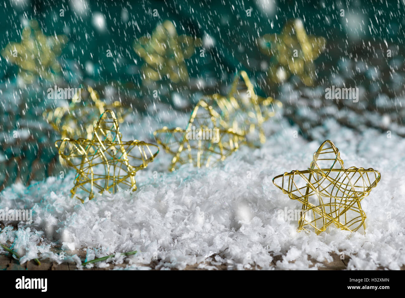 Christmas stars in the snow on the green background Stock Photo - Alamy