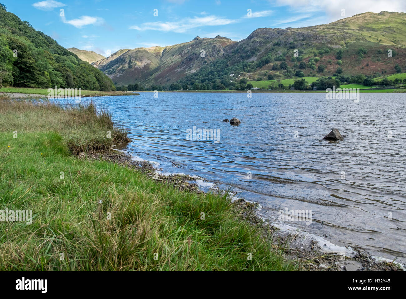 The banks of Brothers Water in the Lake district, Cumbria, with the mountains in the distance. Stock Photo
