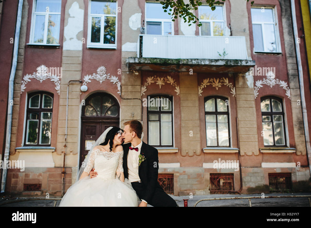 bride and groom posing on the streets Stock Photo - Alamy