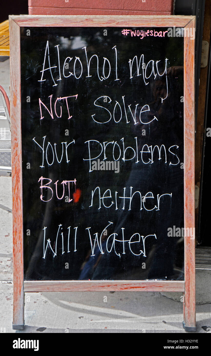 A sign outside Wogie's Bar on Greenwich St. in the West Village suggesting that drinking alcohol is better than drinking water. Stock Photo