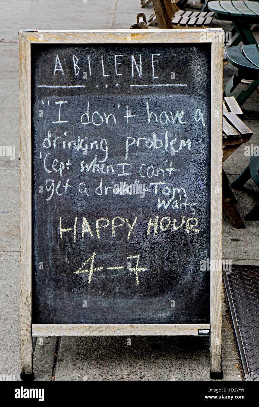 A sign outside the Abilene Bar in Cobble Hill, Brooklyn, New York with a Tom Waits quote about his affection for drinking. Stock Photo