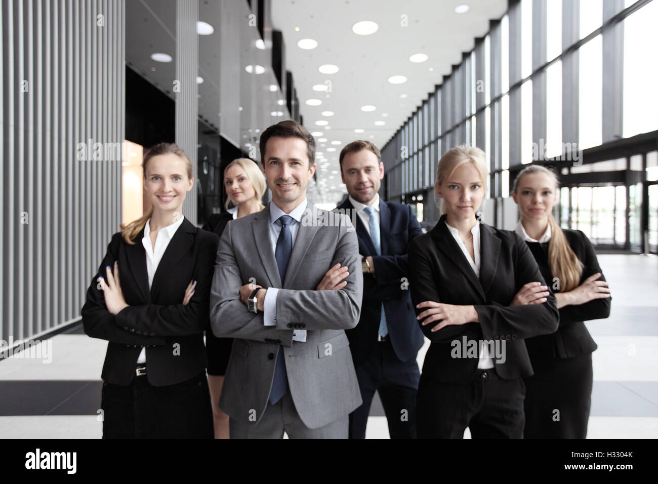 Portrait of successful smiling business team in office building Stock ...