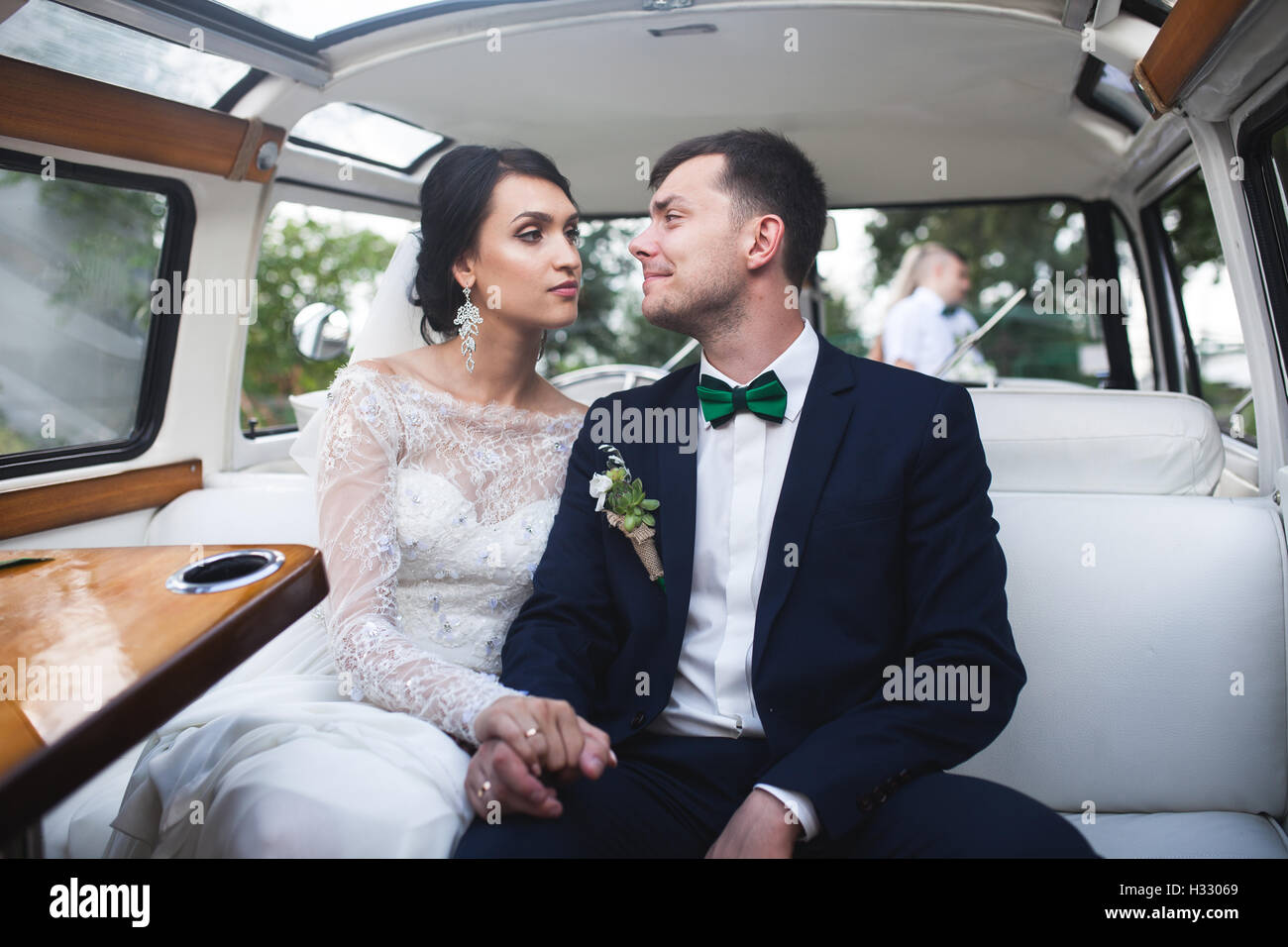 bride and groom sitting in the car Stock Photo - Alamy