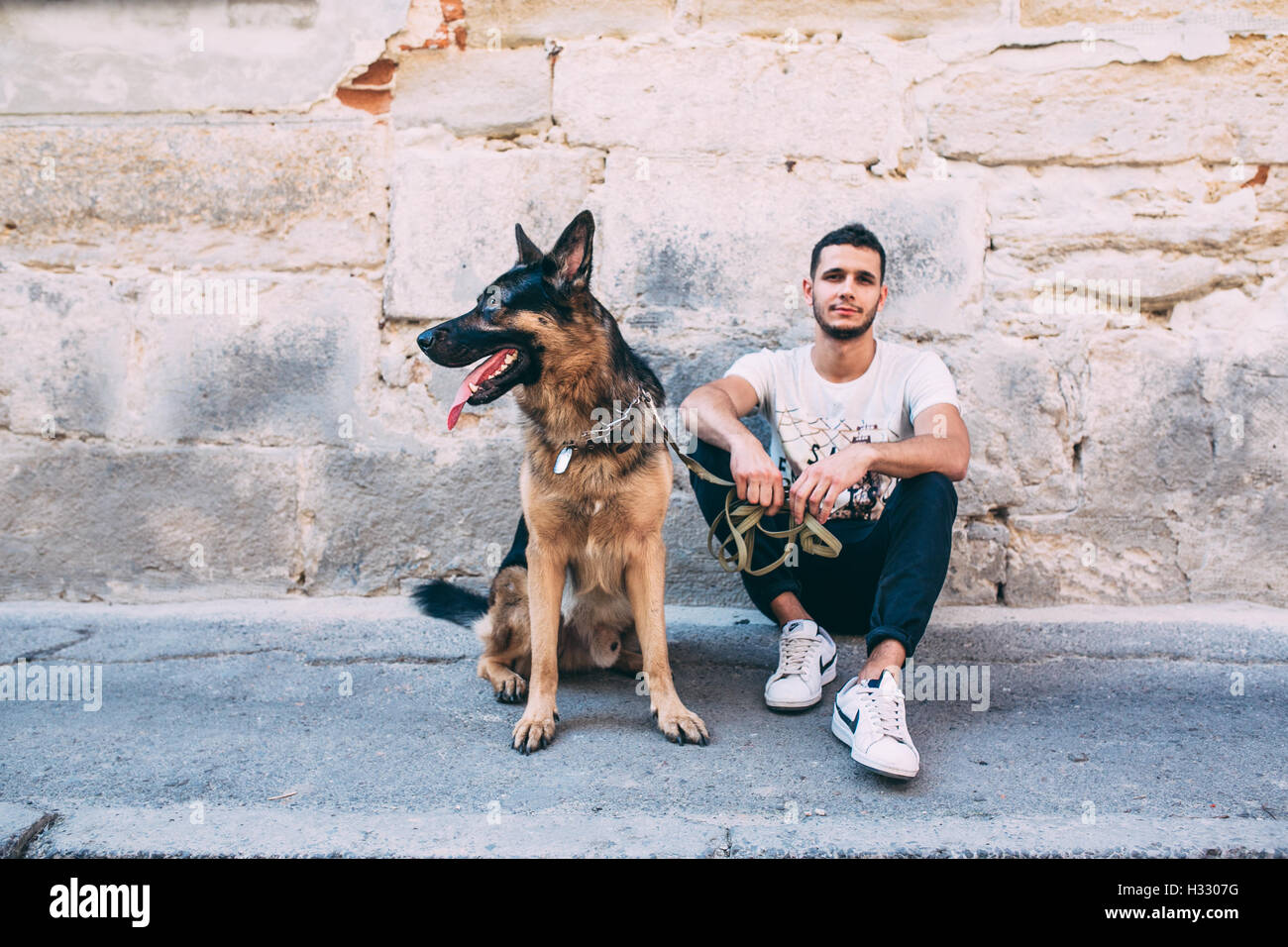 man and dog posing on the street Stock Photo