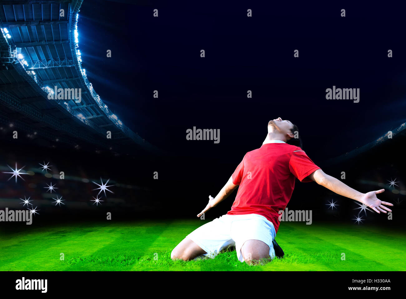 Soccer player celebrating goal on field of stadium Stock Photo
