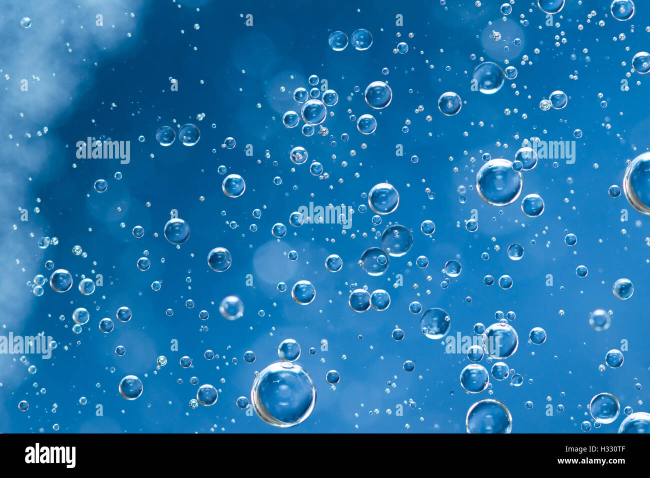 Refreshing light blue air bubbles floating in water Stock Photo