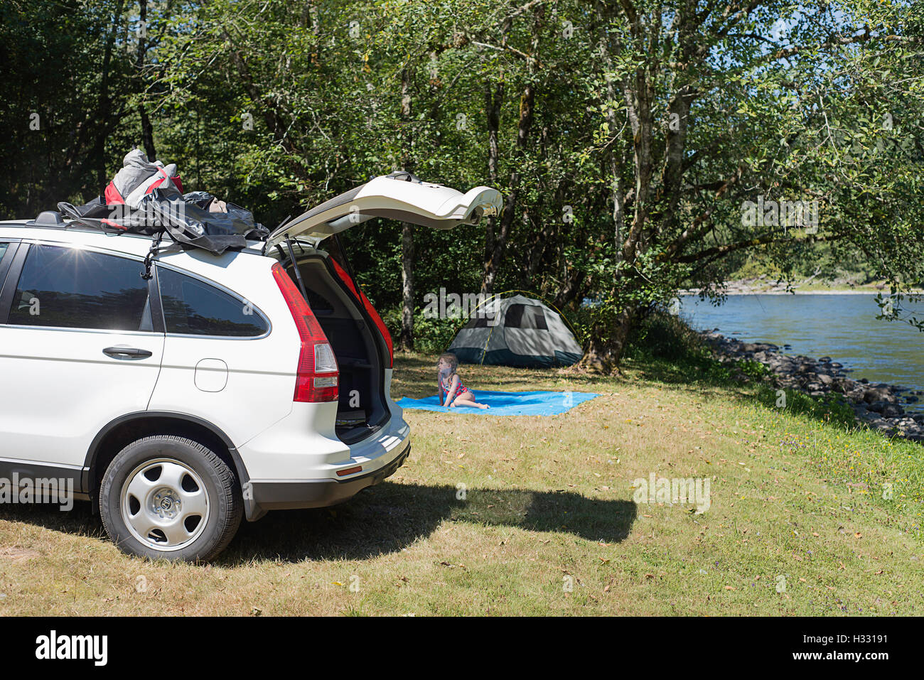 Camping along the bank of a river Stock Photo - Alamy