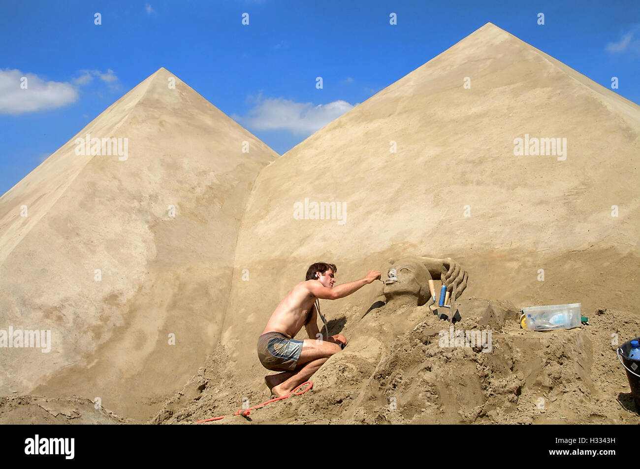 Man making sand sculpture on hi-res stock photography and images - Alamy