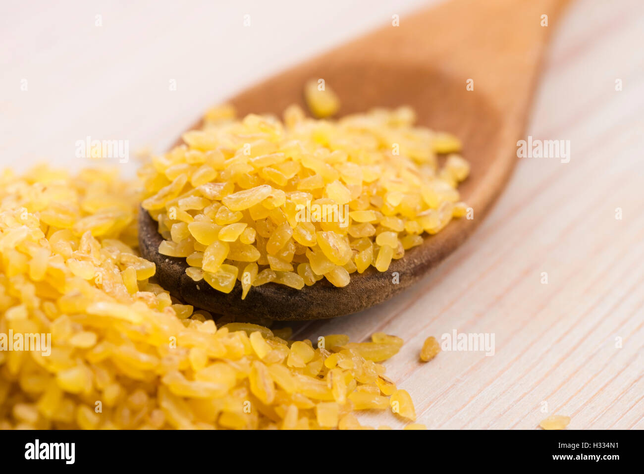 bulgur wheat in wooden spoon Stock Photo - Alamy