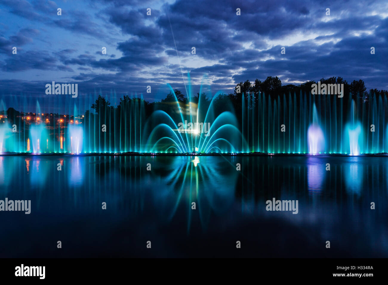 Night magic show of fountains on the central waterfront Roshen Stock Photo