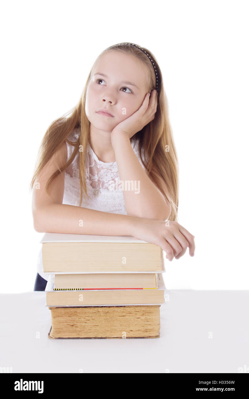 Thoughtful schoolgirl with pile of books Stock Photo - Alamy