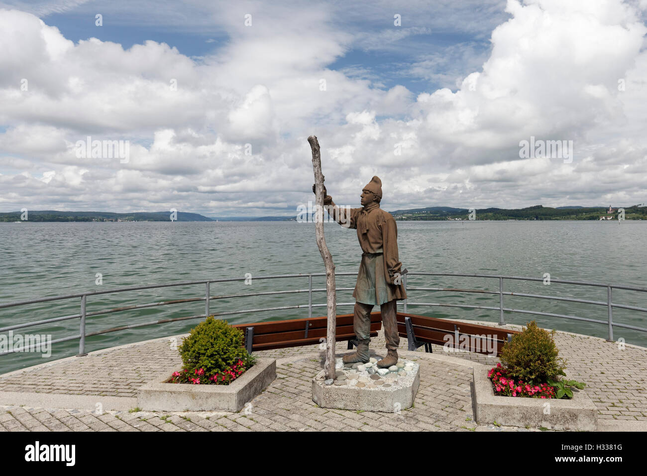 Statue of a pile builder at the shipping pier Unteruhldingen, Lake Constance, Baden-Württemberg, Germany Stock Photo