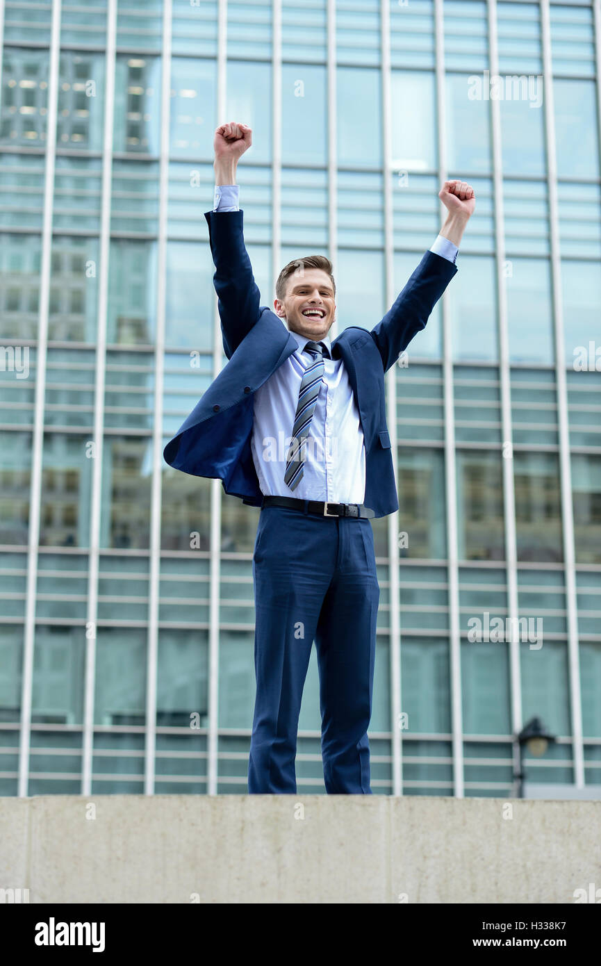 Excited businessman raising his arms Stock Photo - Alamy