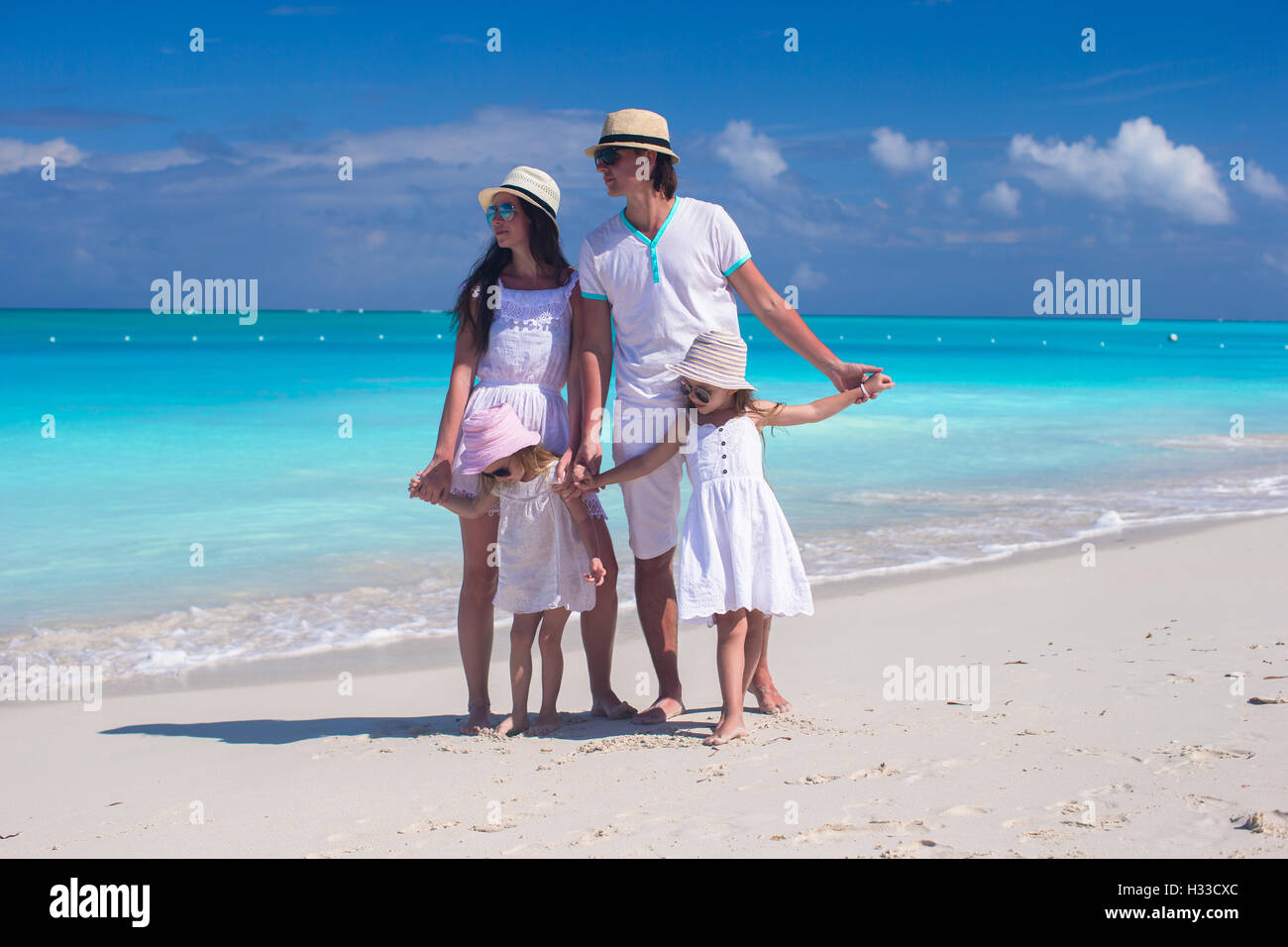 Family of four on caribbean beach summer vacation Stock Photo - Alamy