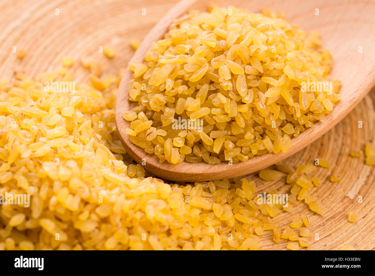 bulgur wheat in wooden spoon Stock Photo - Alamy