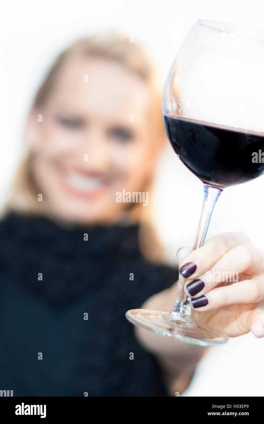 Toasting with a glass of red wine Stock Photo Alamy