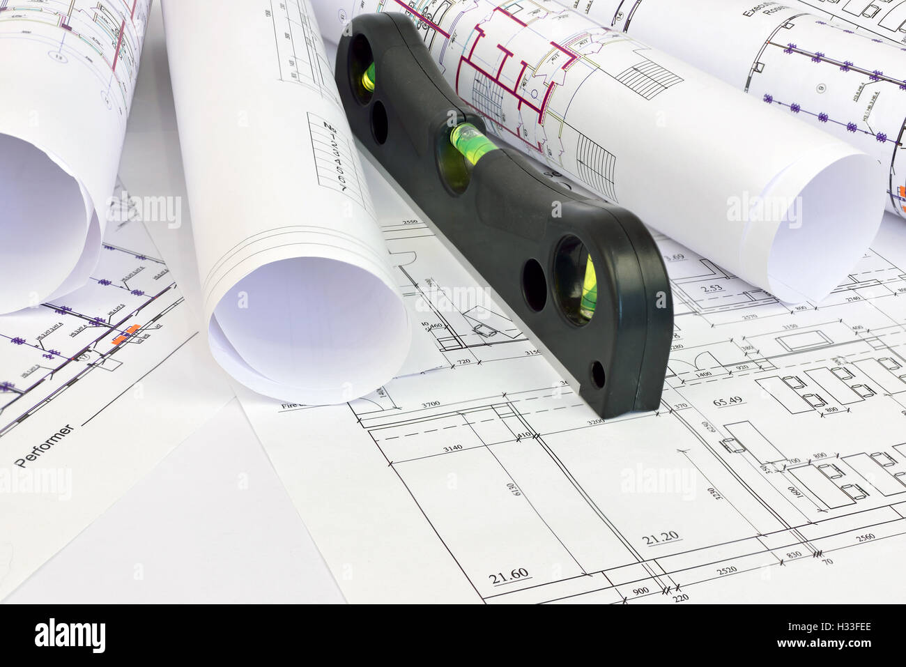 Scrolls drawings and building level Stock Photo - Alamy