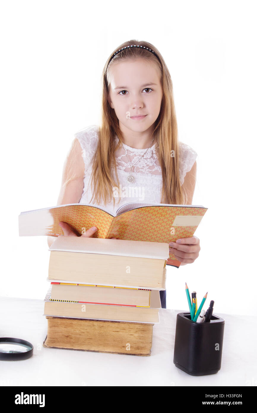 Cute schoolgirl with pile of books Stock Photo - Alamy