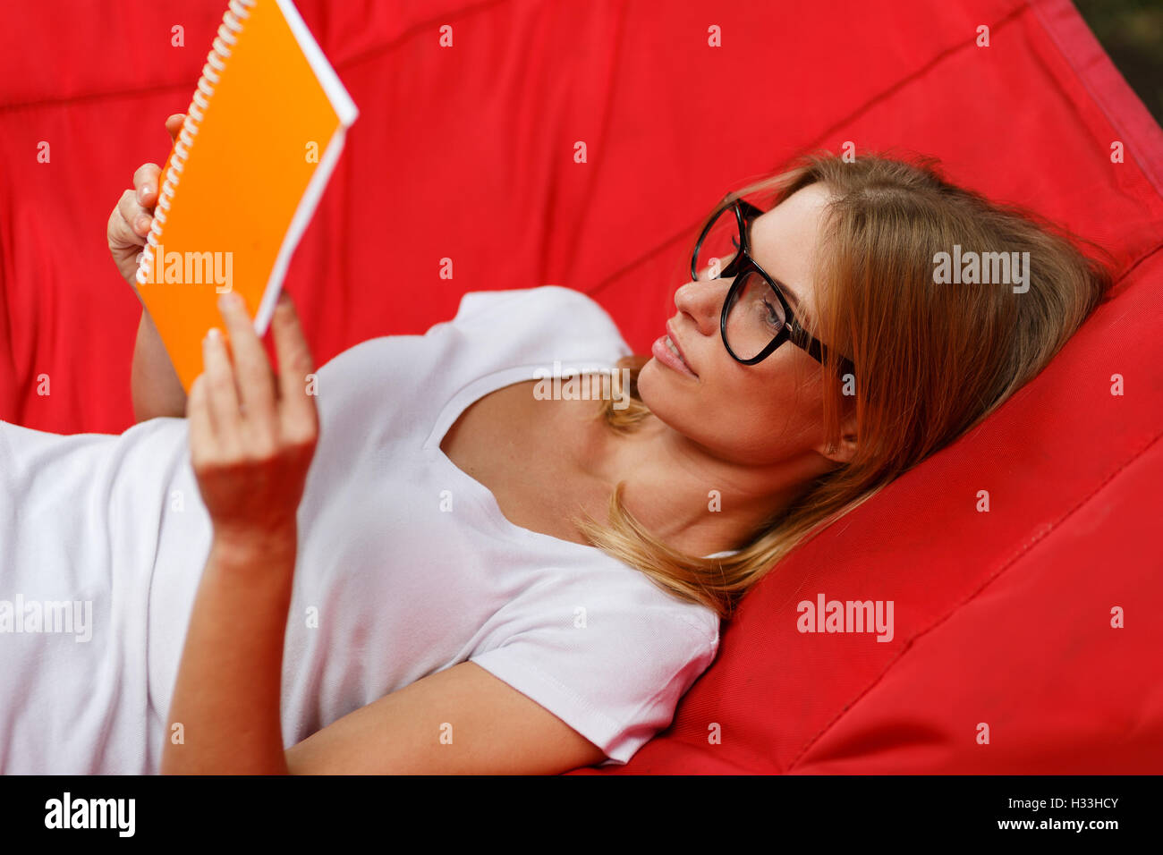 resting lying in hammock reading book Stock Photo - Alamy