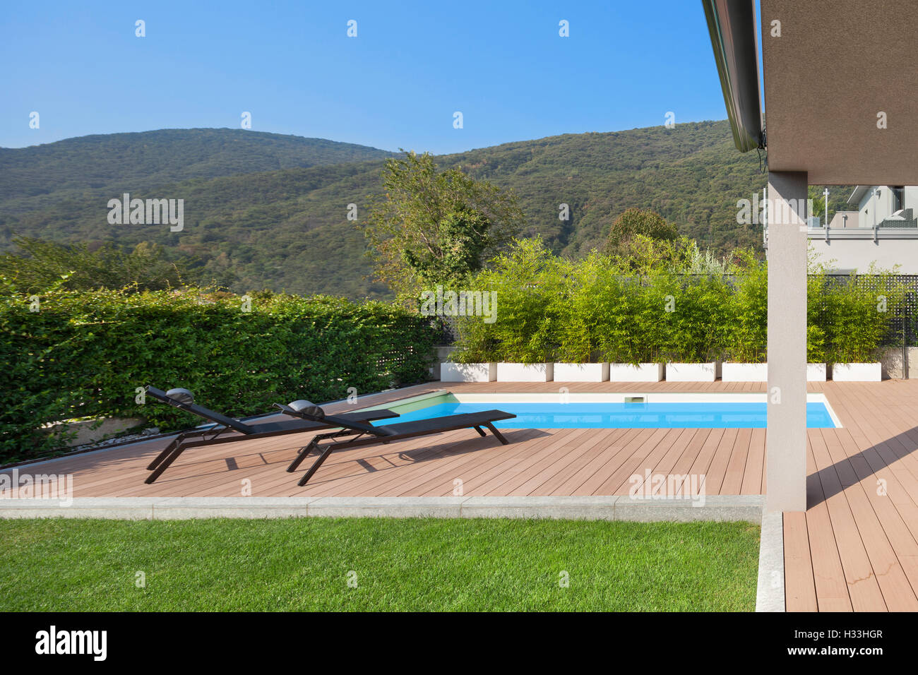 modern house with pool, loungers by the pool Stock Photo Alamy