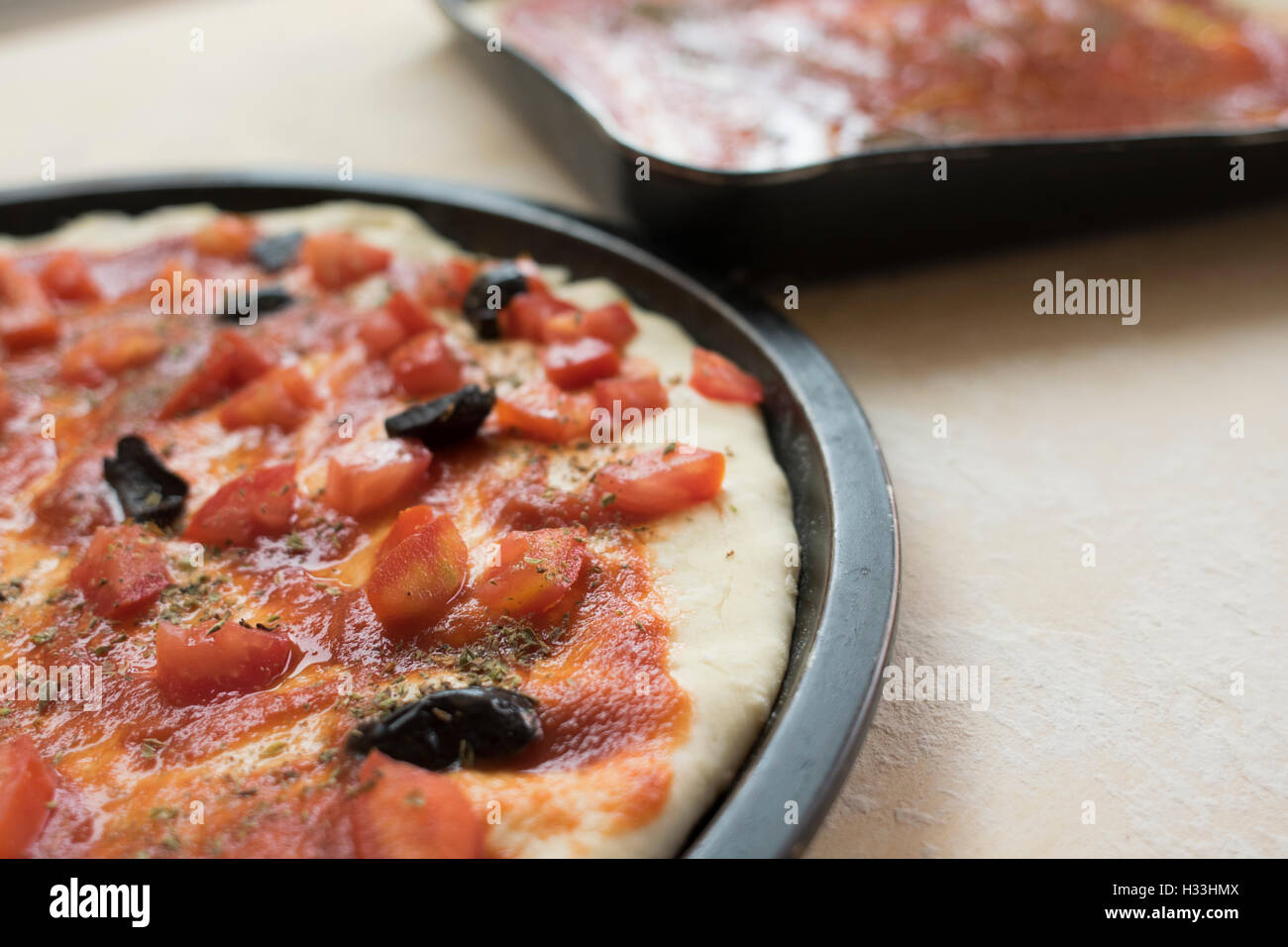 pizza marinara with fresh tomatoes anchovies and olives Stock Photo