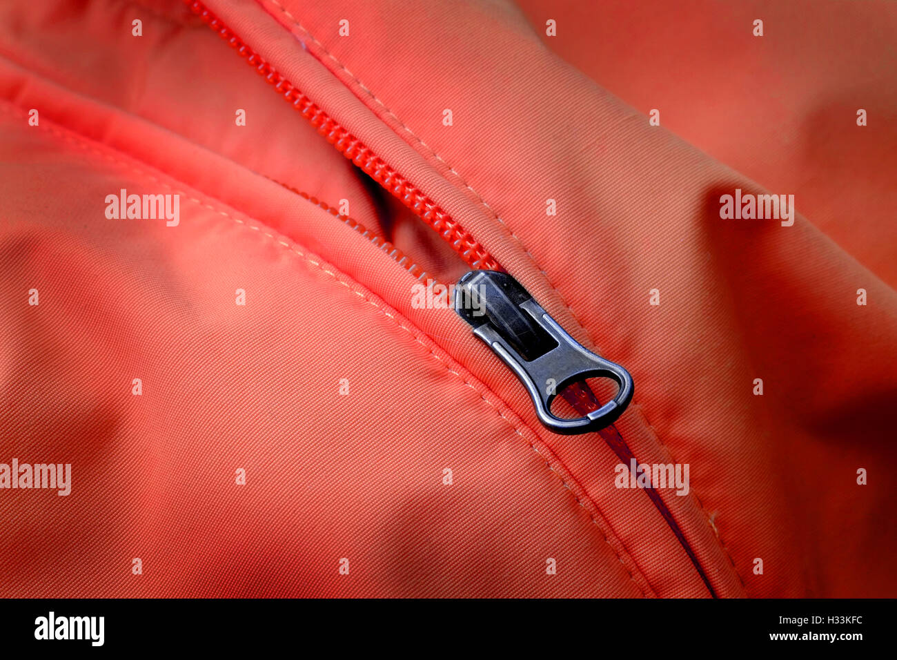Closeup of zipper on Red coat with texture Stock Photo