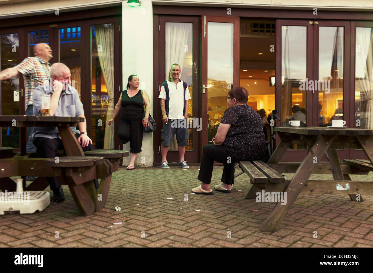 People outside a bar smoking in Bournemouth Stock Photo