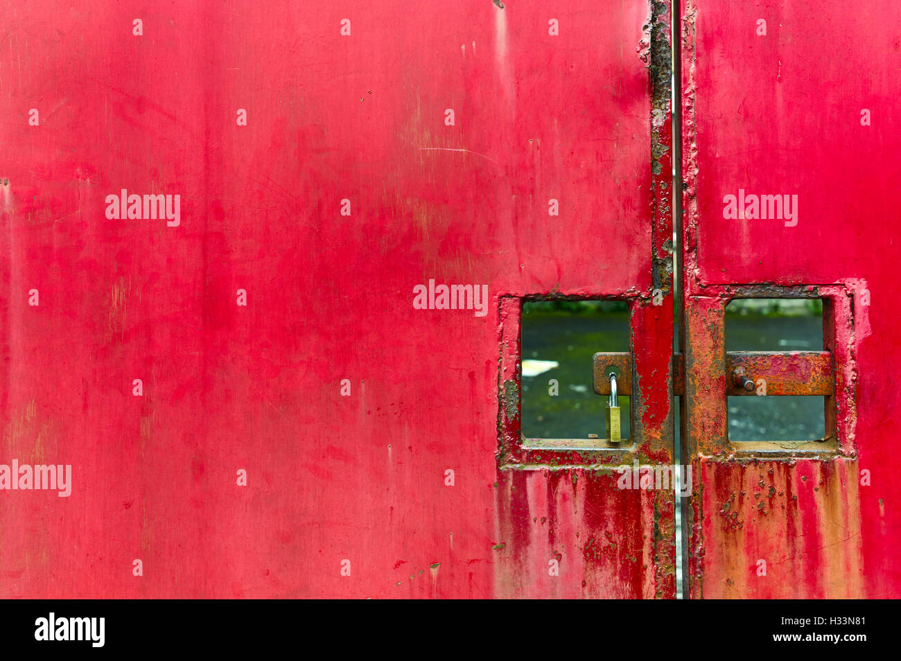 Red metal doors with padlock Stock Photo