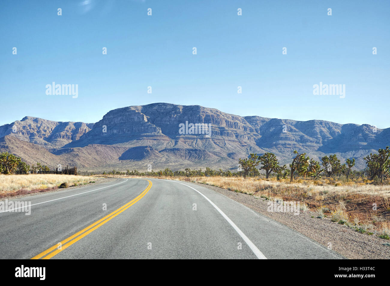 Highway makes left turn in Nevada desert Stock Photo