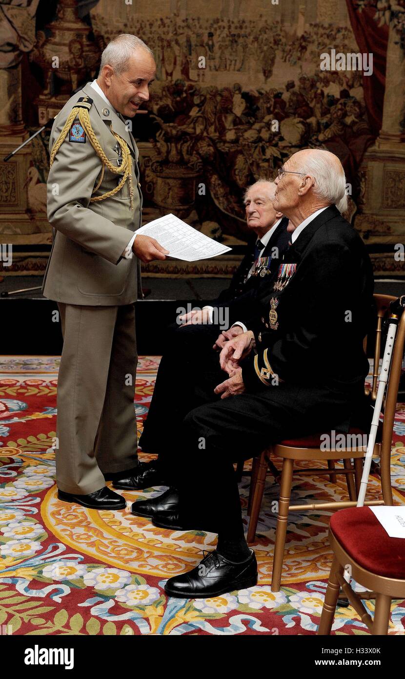 Colonel De Loustal from the French Parachute Regiment talks to veterans prior to them receiving the Legion d'honneur, France's highest distinction, from the French Ambassador Sylvie Bermann for their role in liberating France during the Second World War, during a ceremony at the Ambassador's residence in Kensington, London. Stock Photo