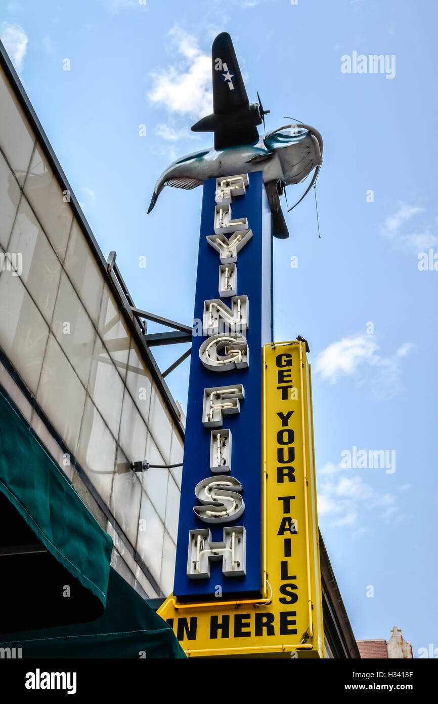 The Flying Fish Restaurant's big blue overhead neon sign in front of entrance with catfish art on South 2nd St., Memphis, TN Stock Photo