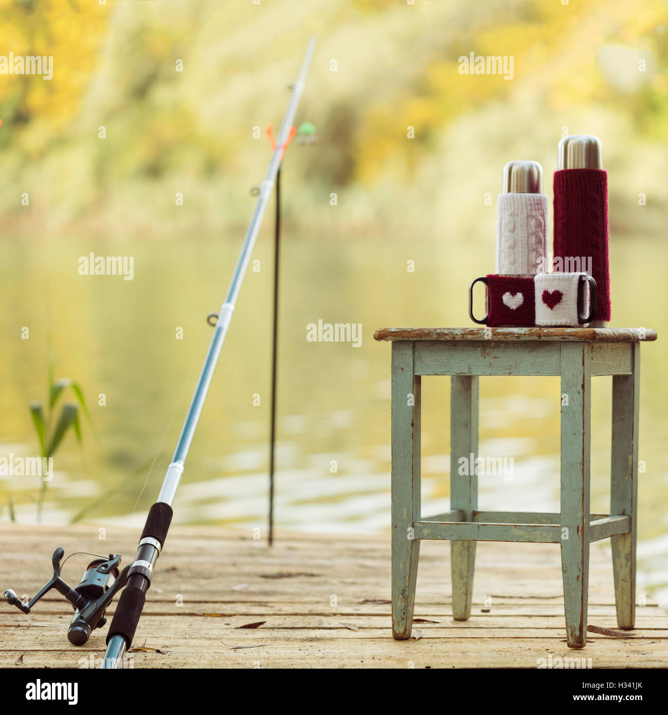 wooden stick fishing rod stand by river Stock Photo - Alamy