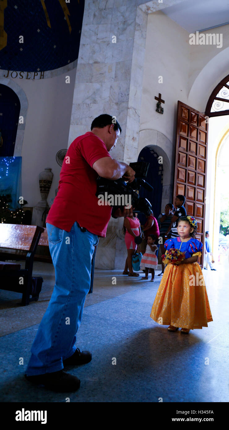 Catedral Nuestra Senora de la Soledad interior in Old Town Acapulco, Mexico. Little girl being filmed. Stock Photo