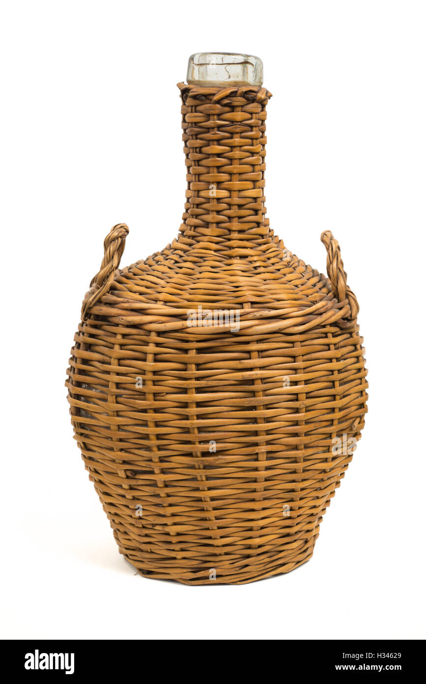vintage glass carafe with wicker cover, isolated Stock Photo