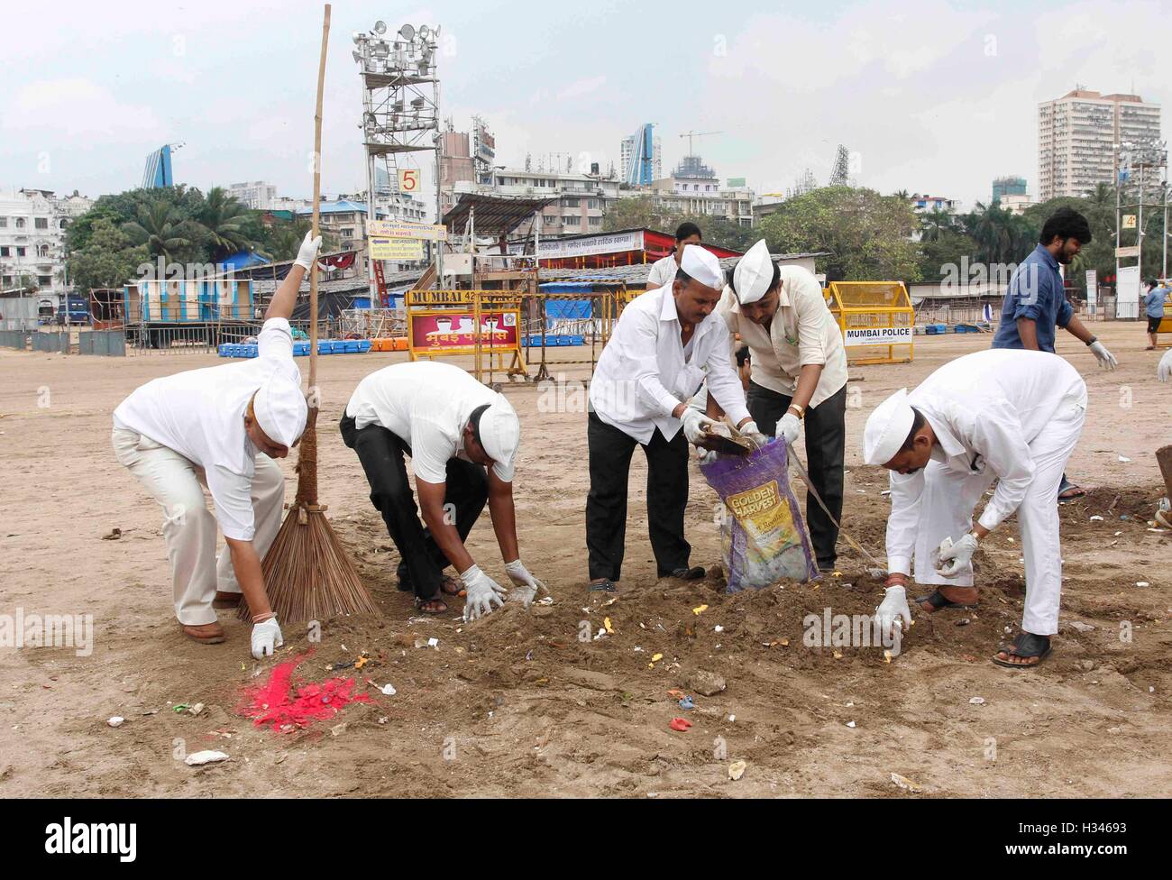 Dabbawalas clean the Chowpatty beach in Mumbai, India on September 16, 2016, and remove the leftover Stock Photo