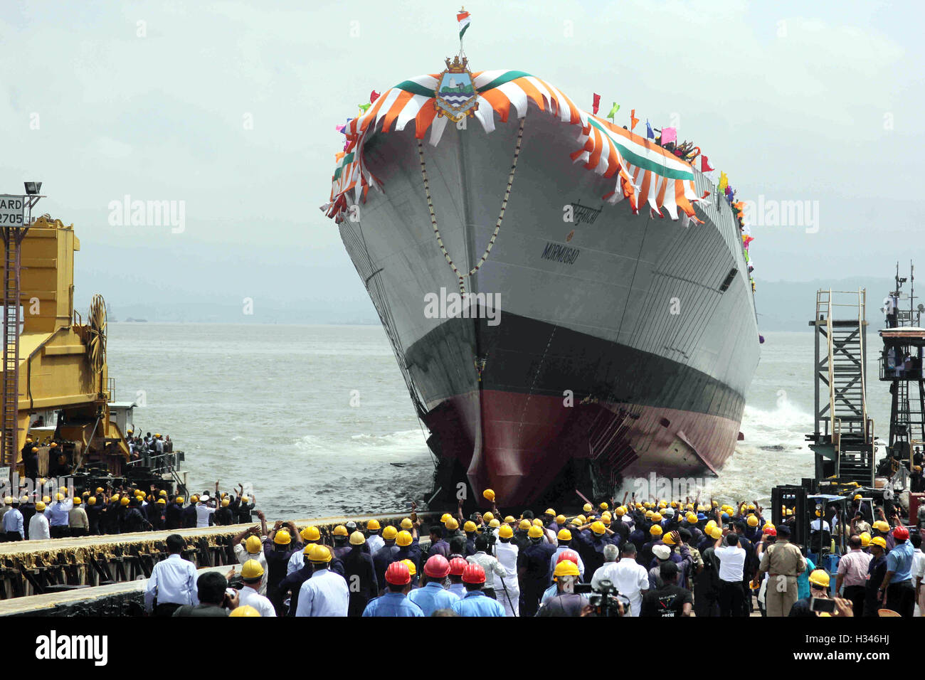 Mormugao stealth destroyer rolls into sea during its launch in Mumbai, India on September 17, 2016 Stock Photo
